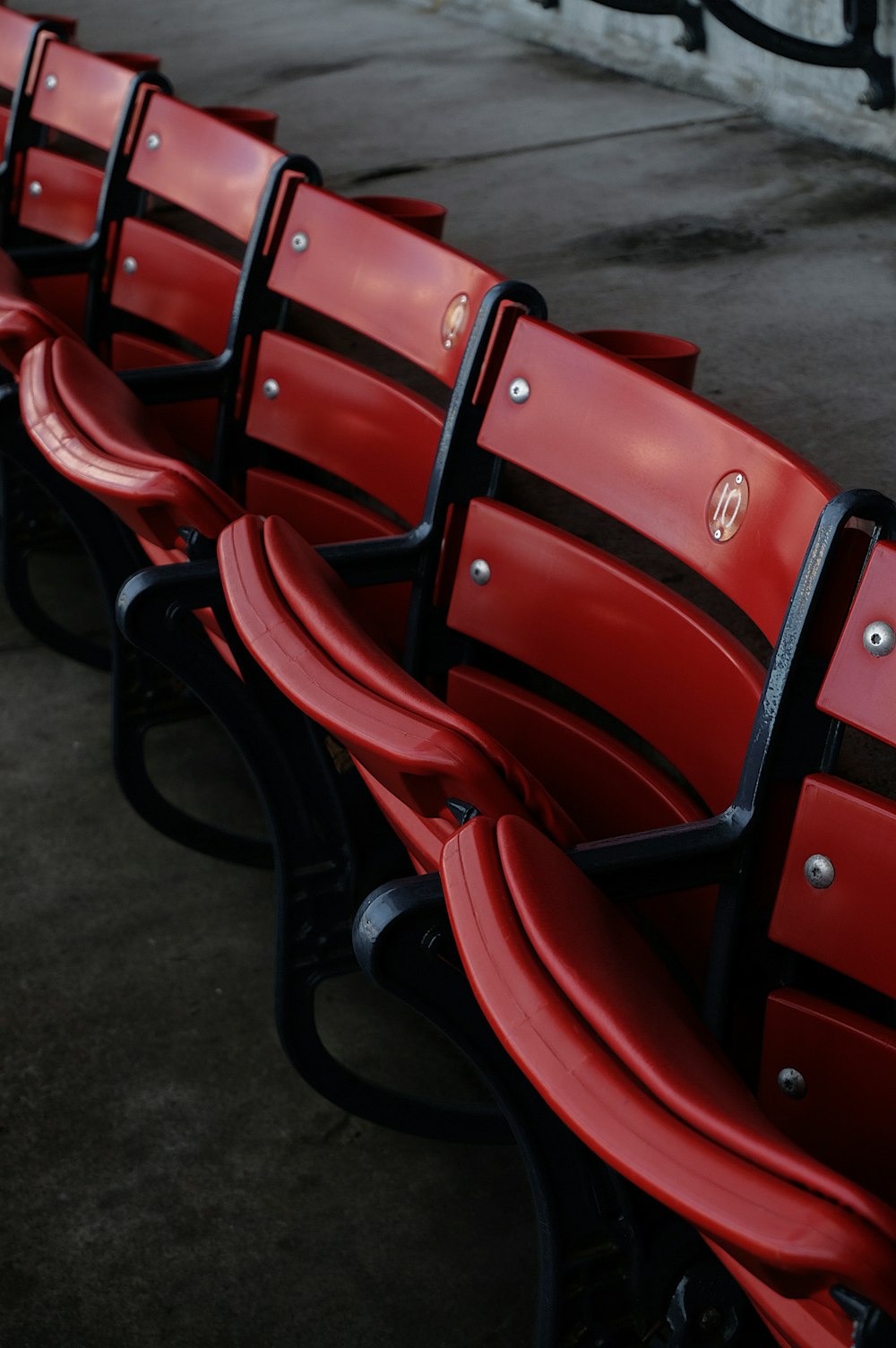 a row of red seats sitting next to each other