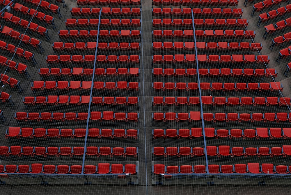 a row of red seats in a stadium