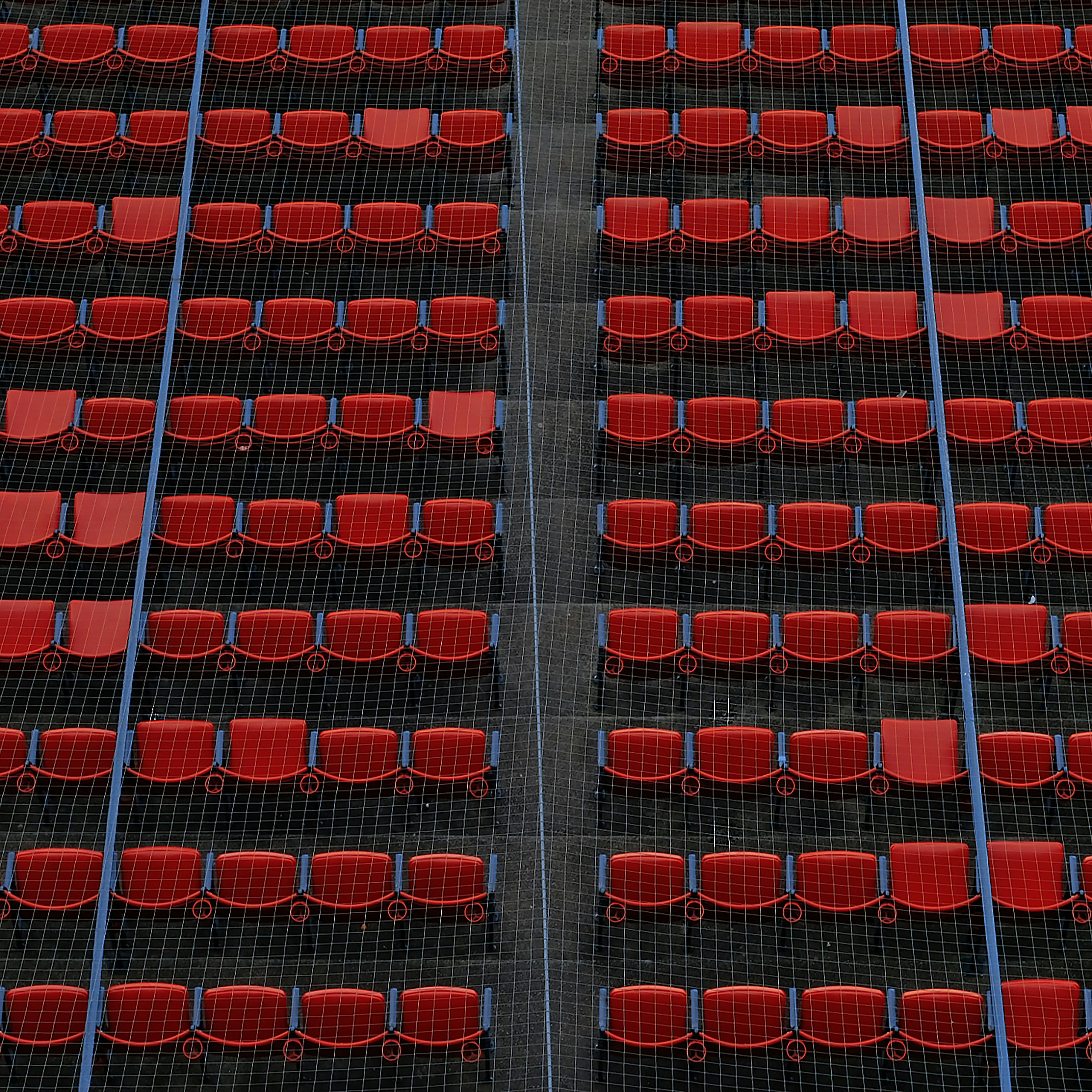 a row of red chairs sitting next to each other