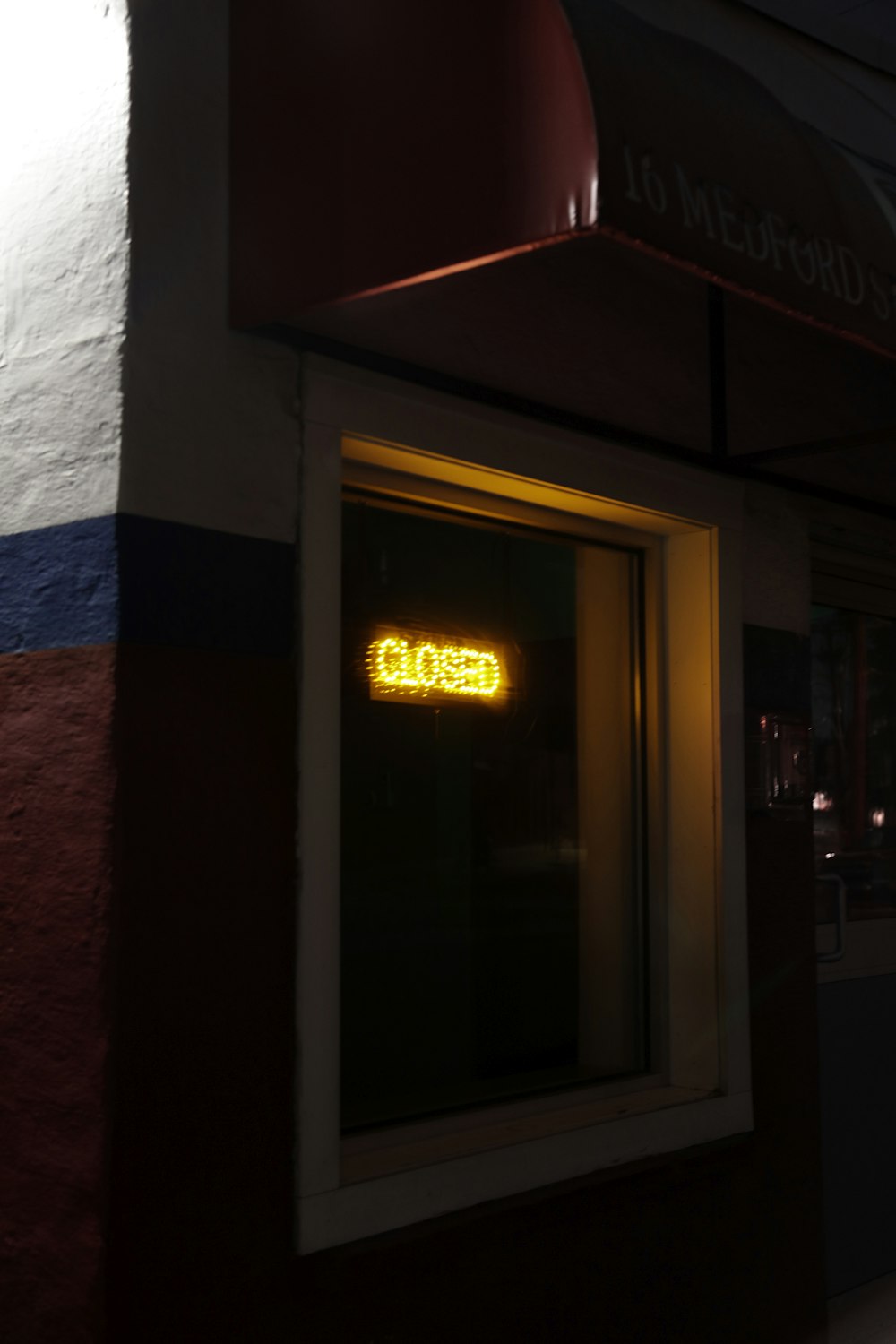 a close up of a neon sign on a building