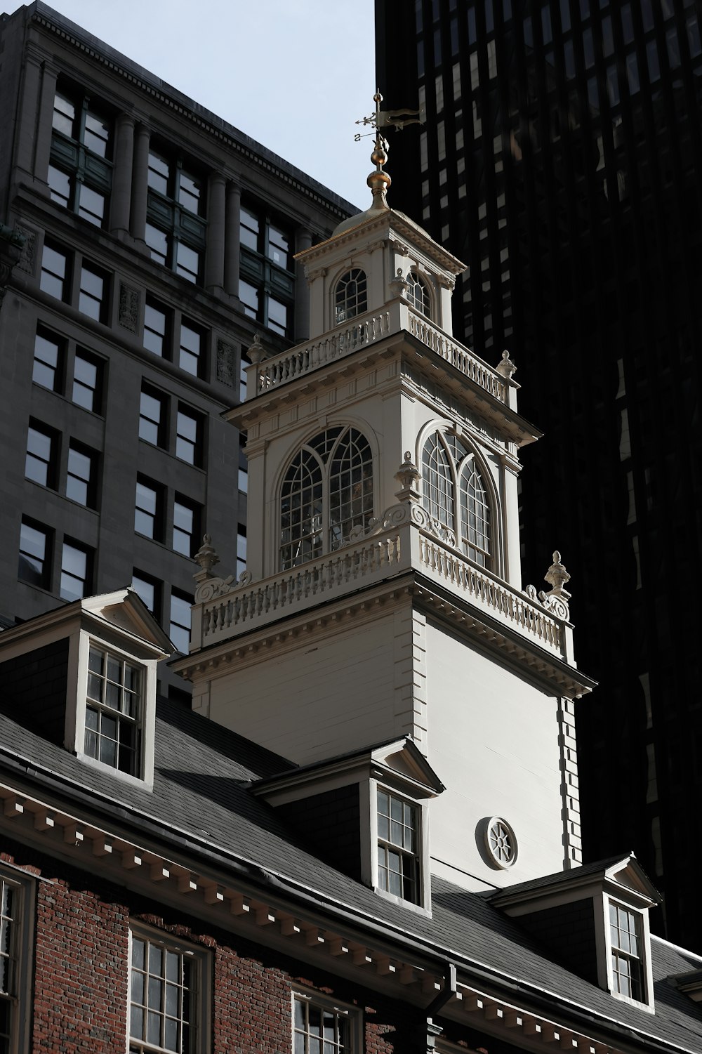 a clock tower on top of a building in a city