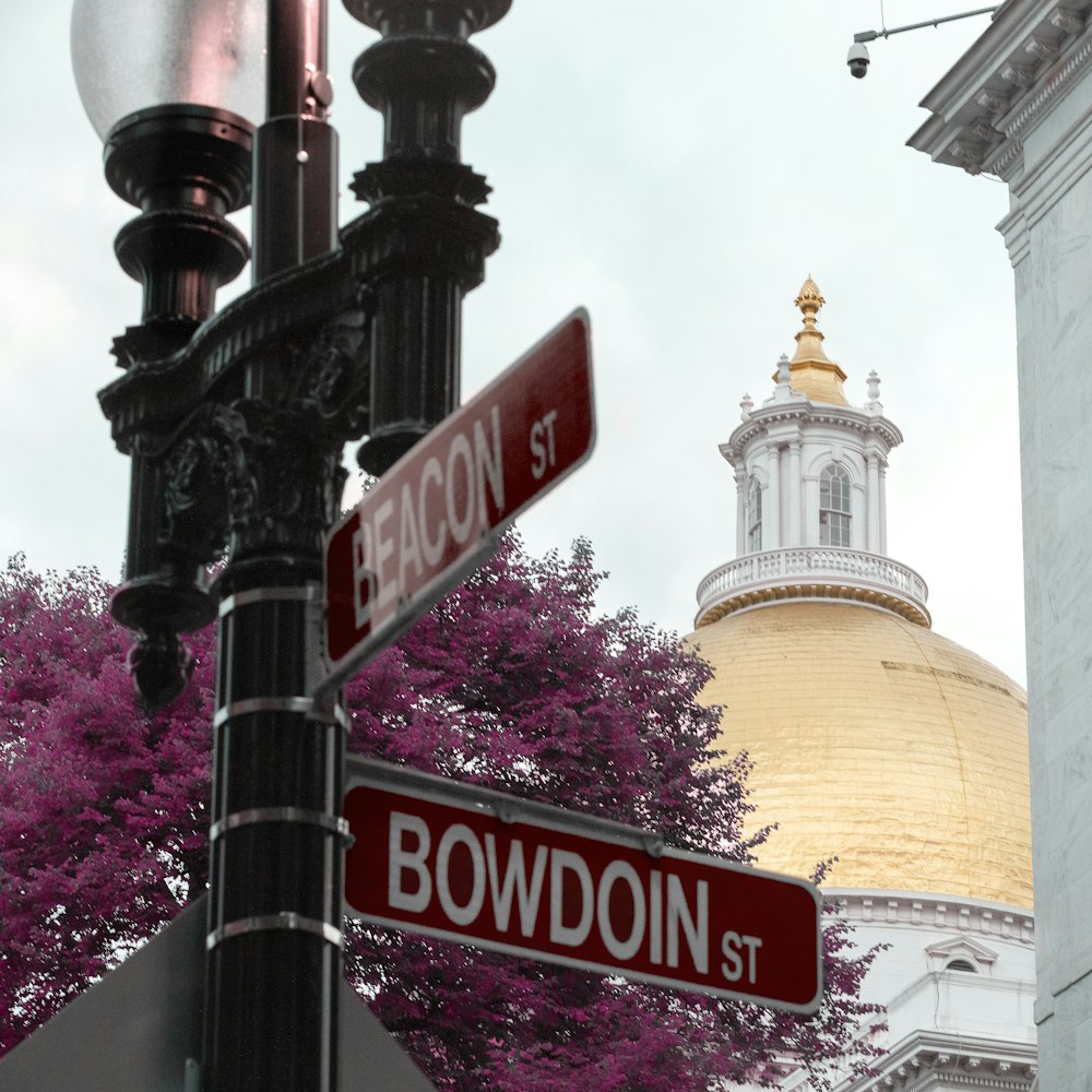 a street sign in front of a building with a dome in the background