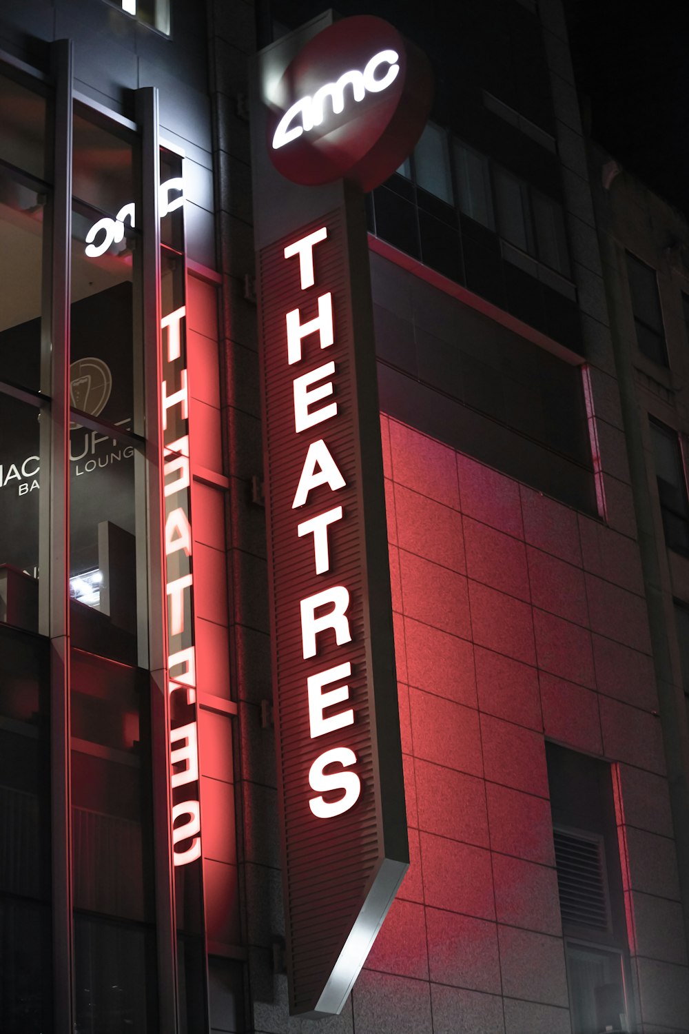 a red and black building with a sign that says theater