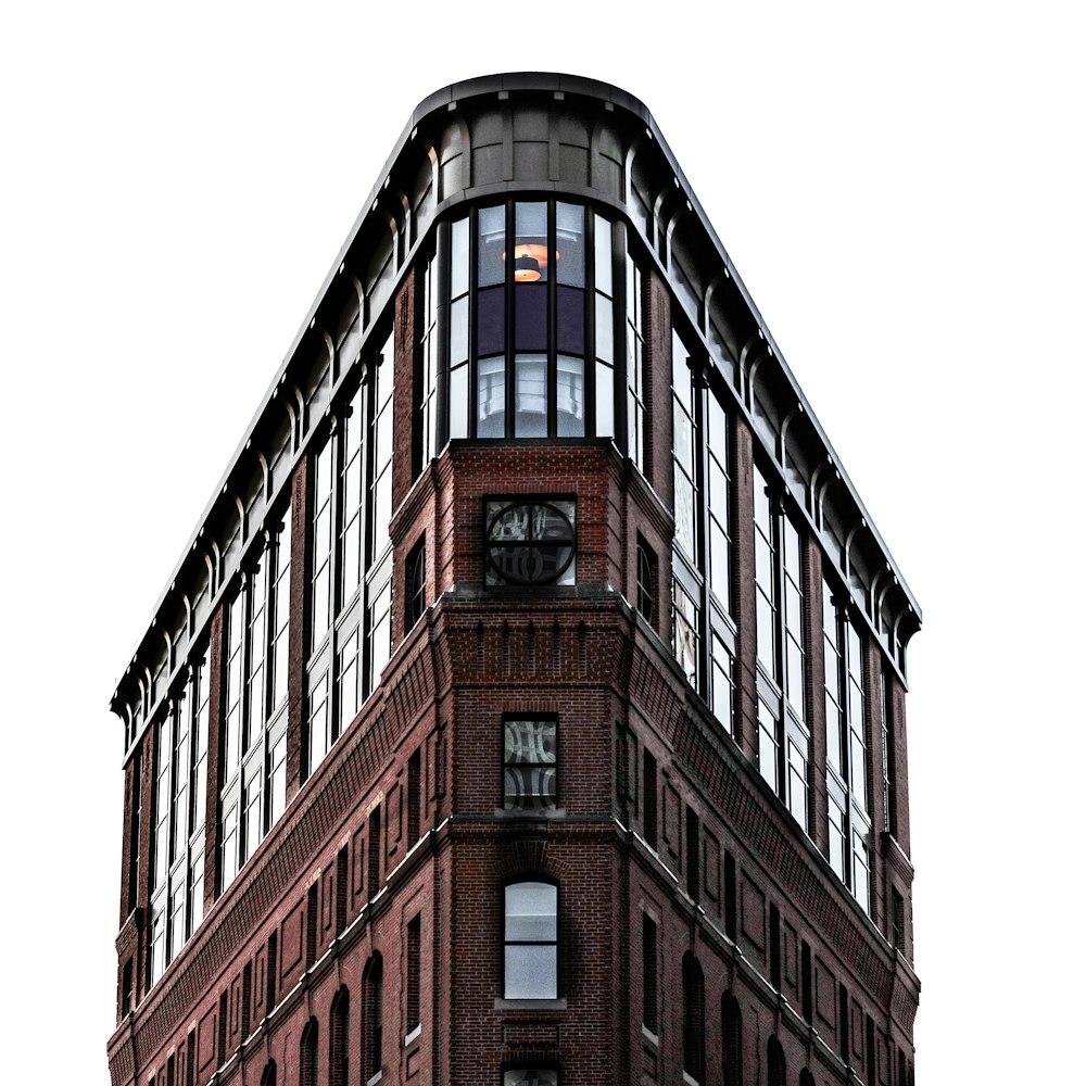 a tall brick building with a clock on the top of it