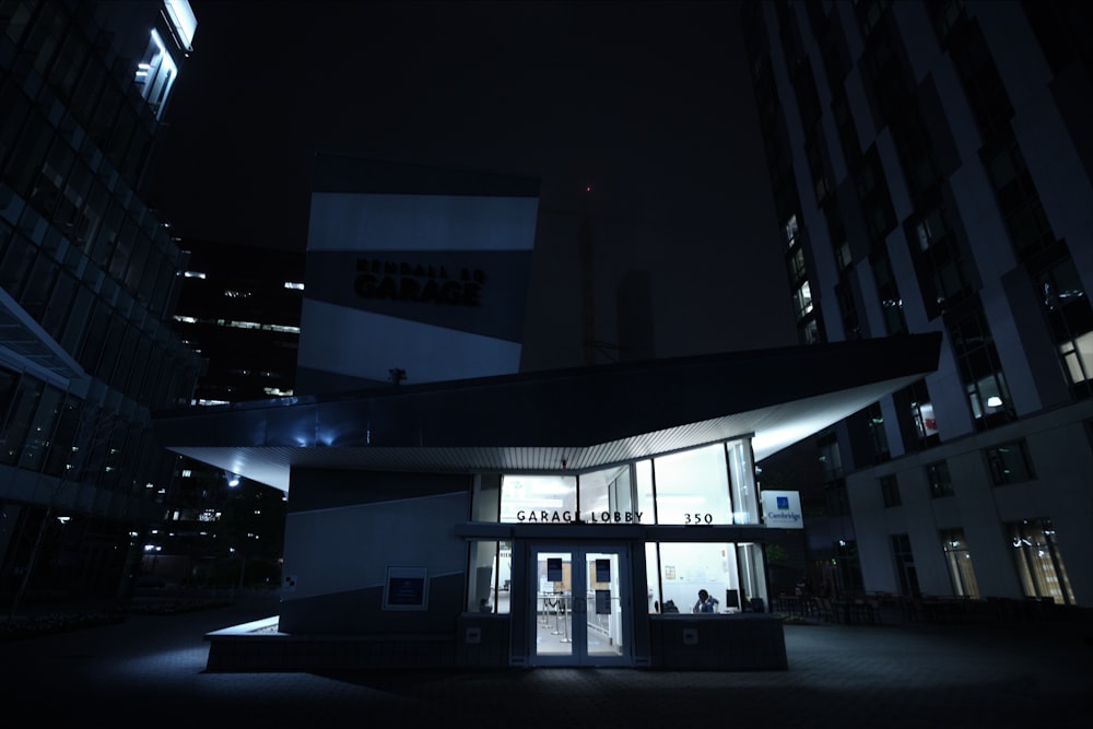 a building lit up at night with the lights on