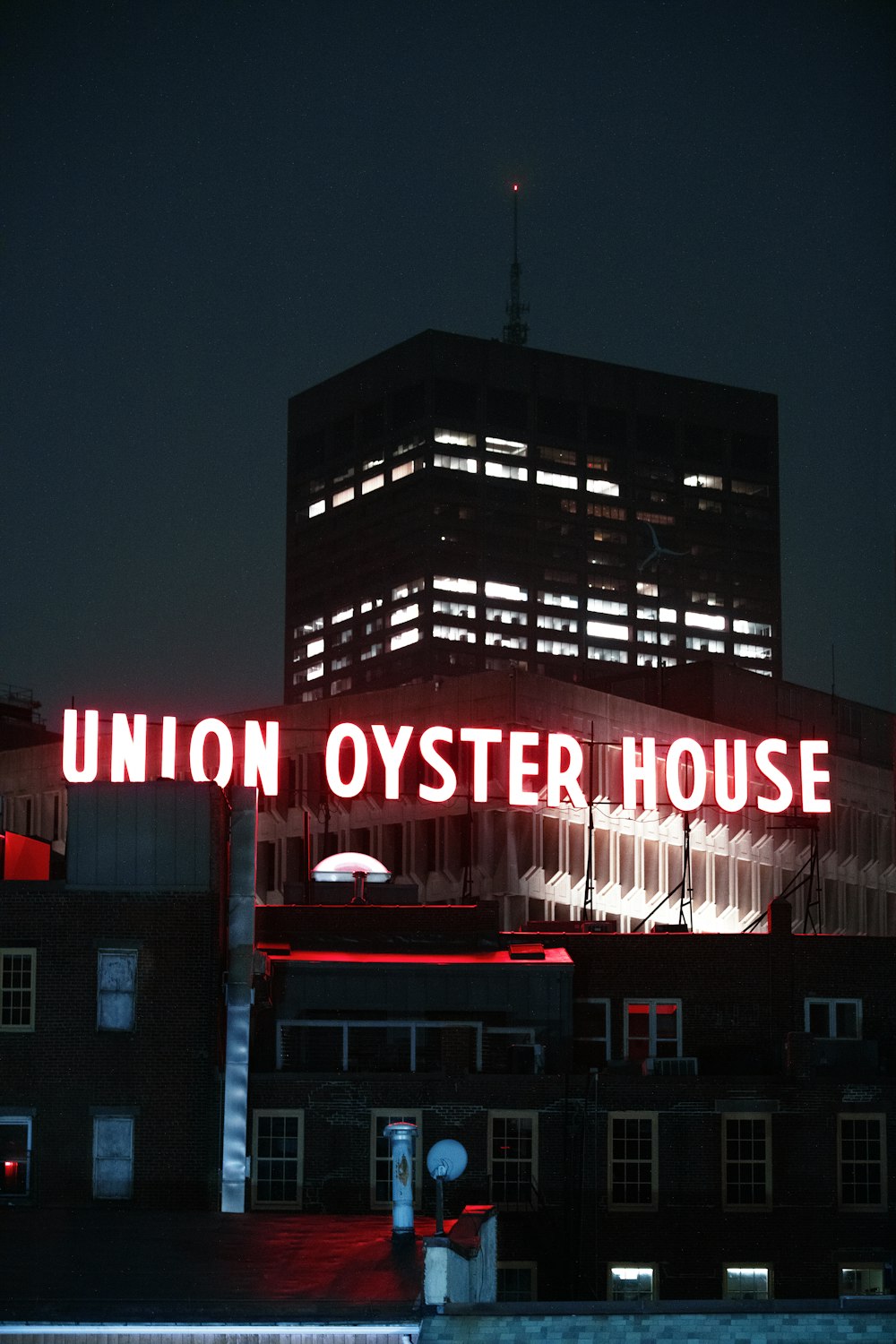 a building with a neon sign that reads union oyster house