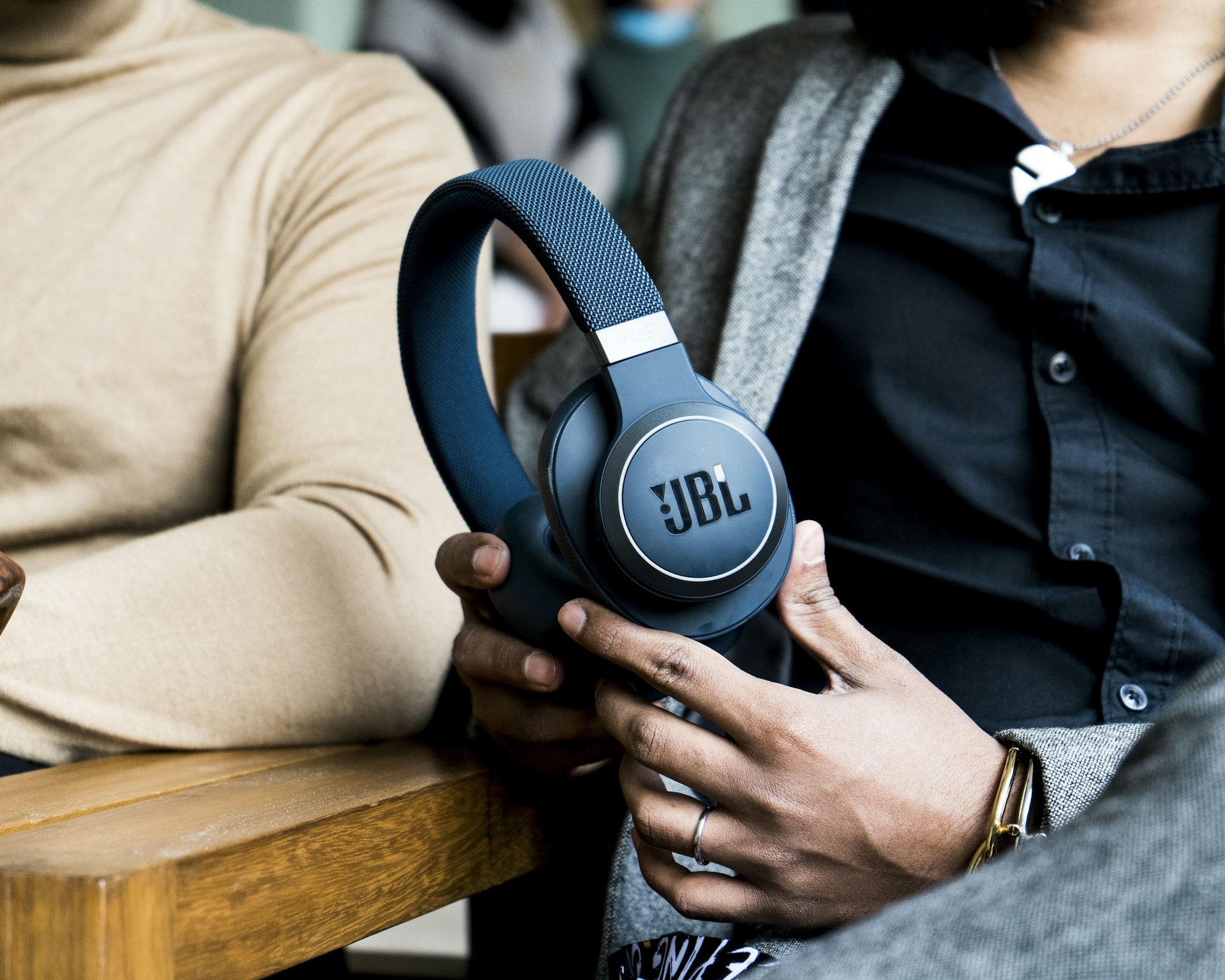 a person holding a pair of headphones in their hands