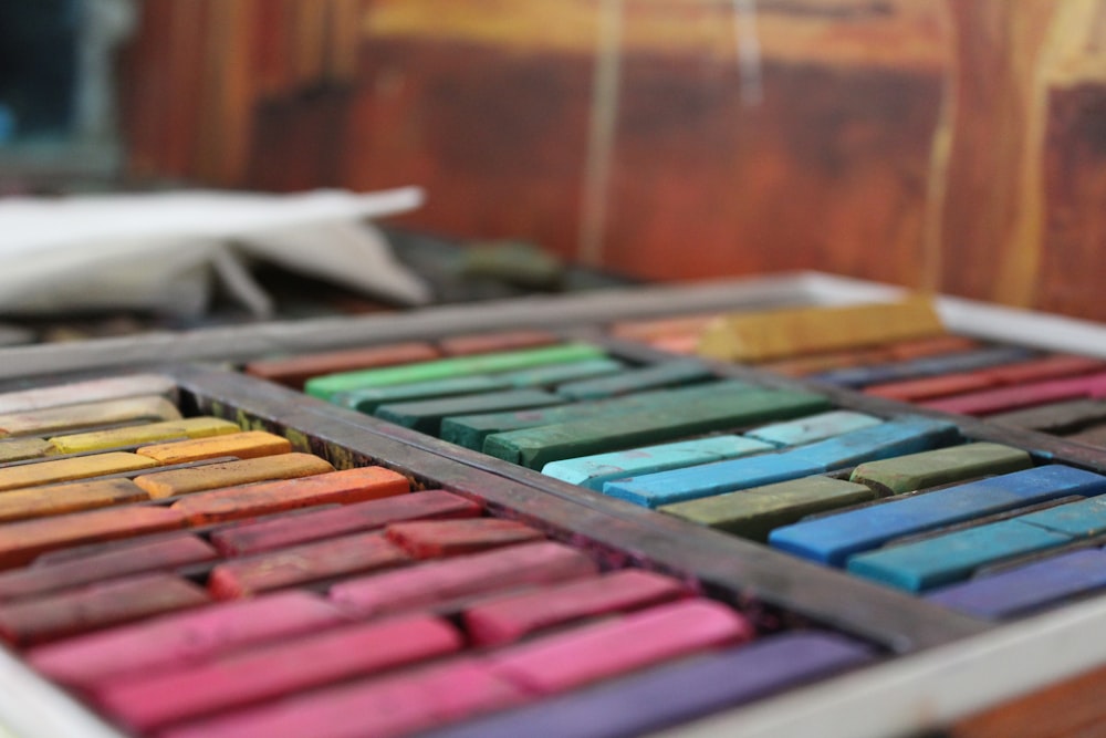 a close up of a tray of colored crayons