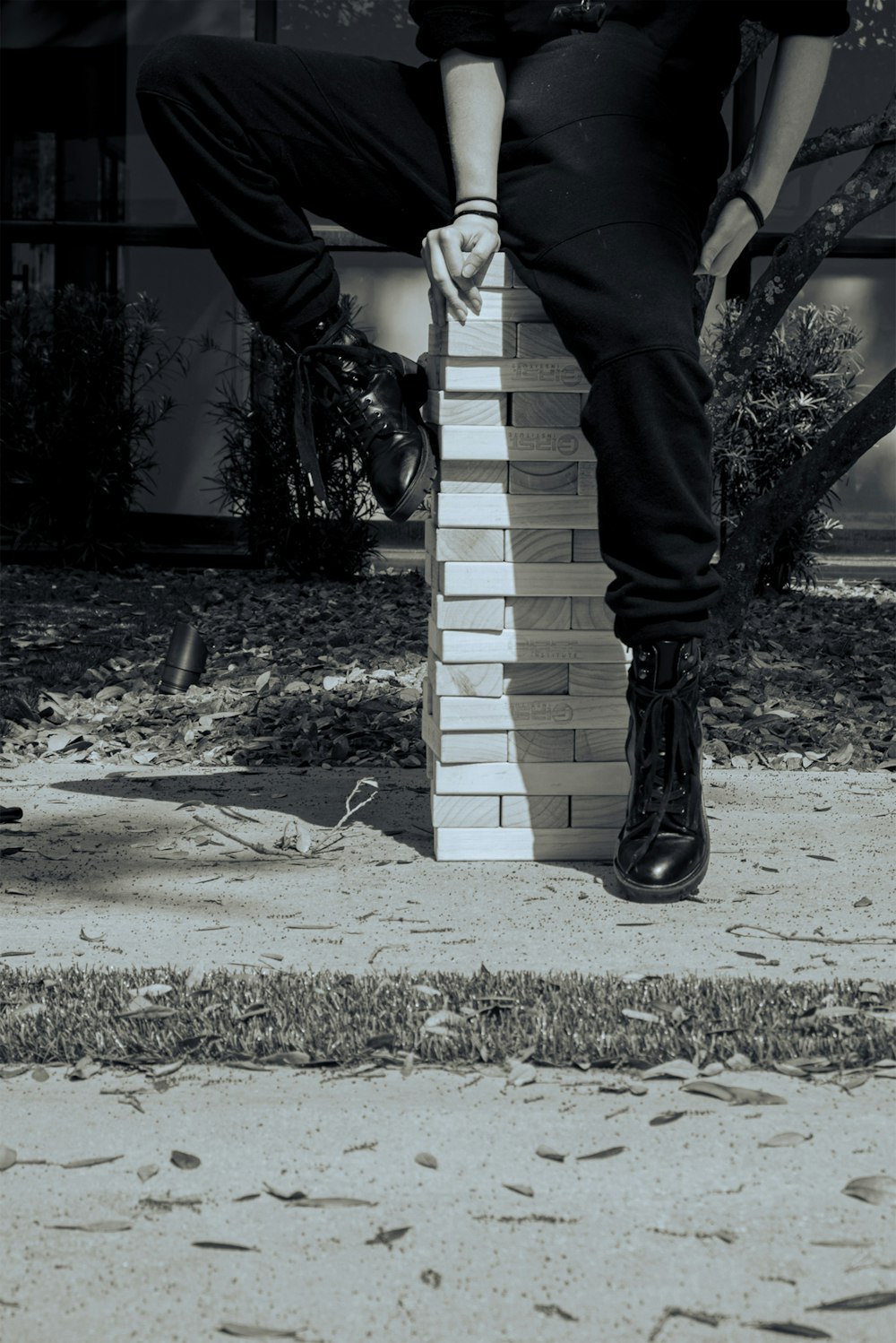 a man is leaning on a brick wall