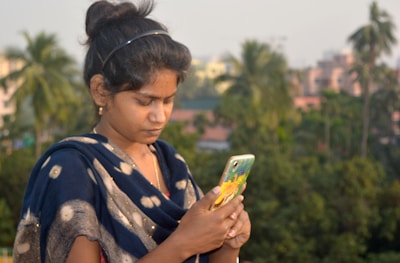 a woman is looking at her cell phone
