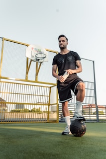 a man standing on top of a soccer ball