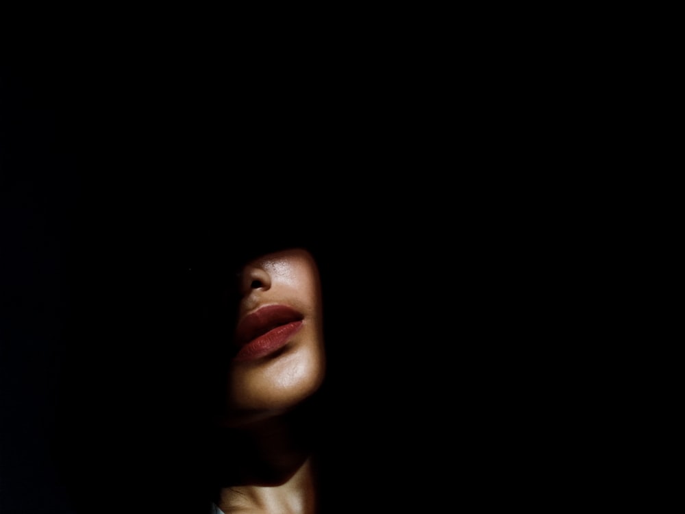a woman's face in the dark with her eyes closed