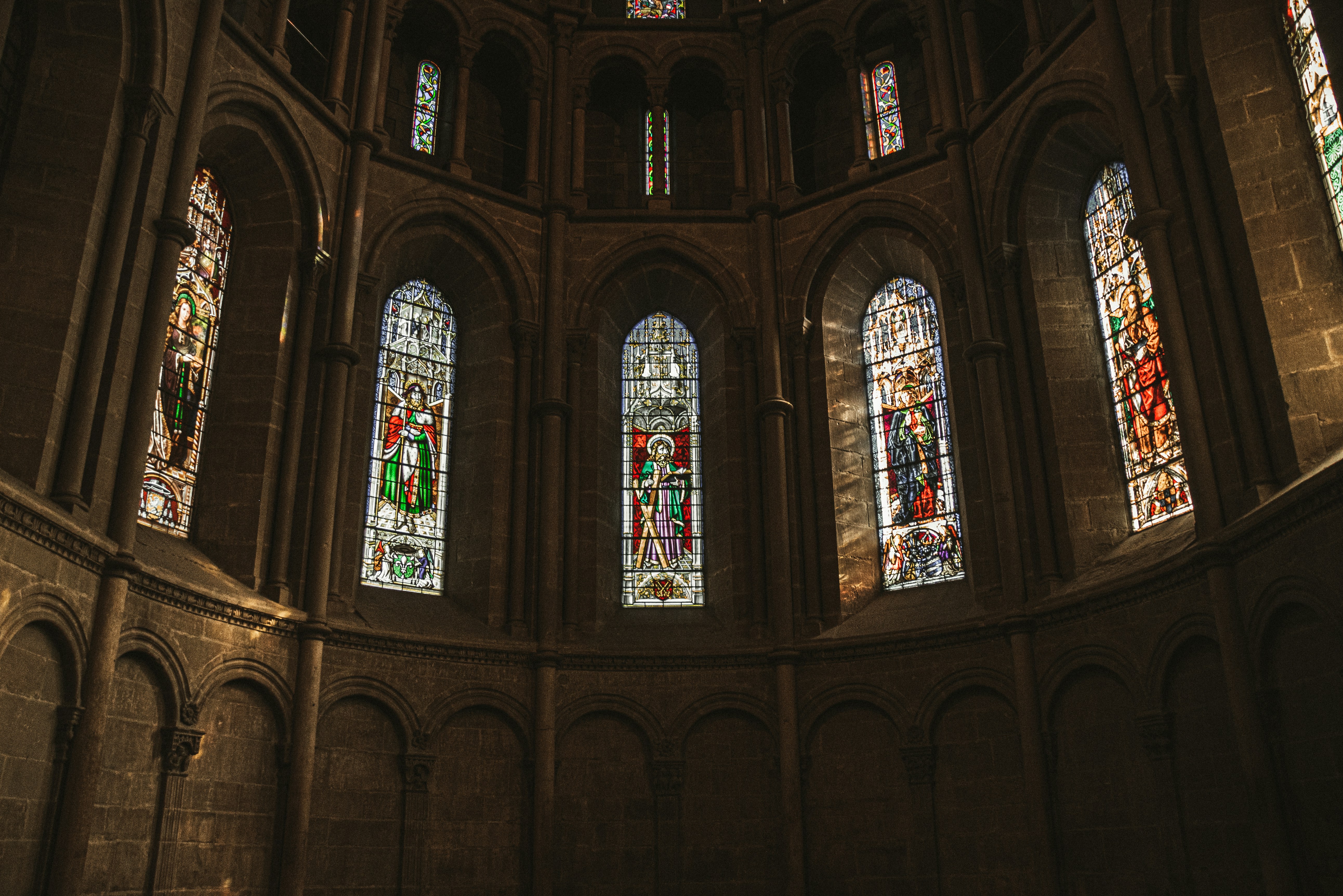 a large room filled with lots of stained glass windows