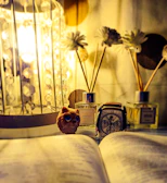 A calm evening scene showing g-mode supplements next to a lit candle and an open book with electric green accents.