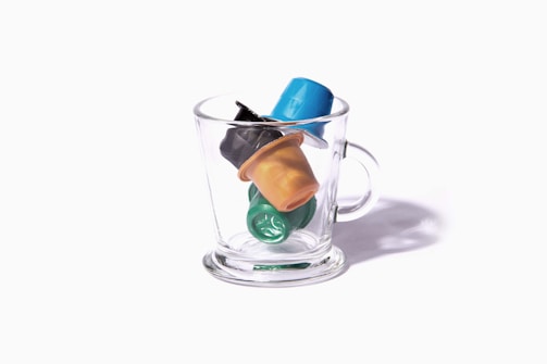 a glass cup filled with different colored items