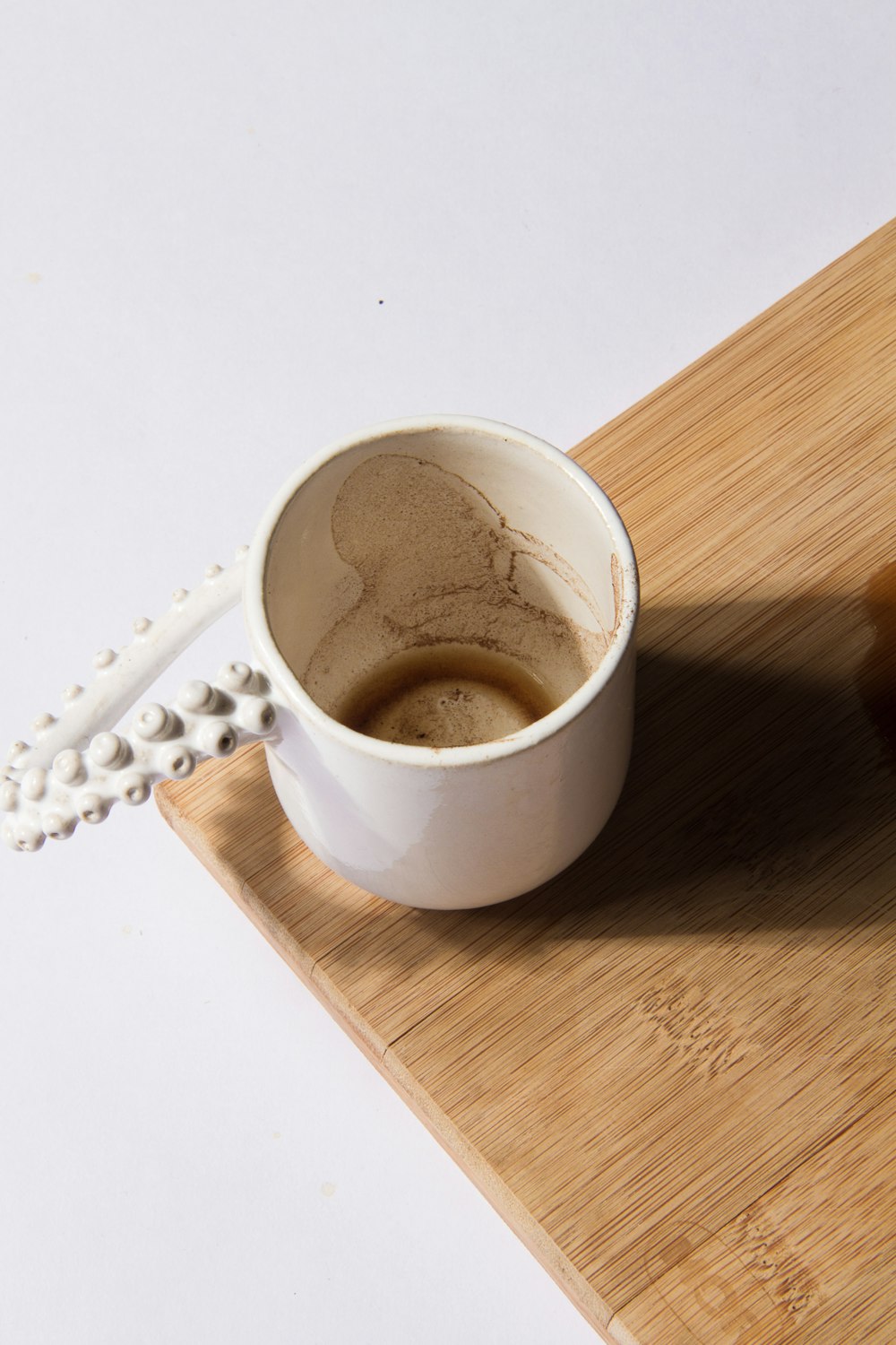 a cup of coffee sitting on top of a wooden tray