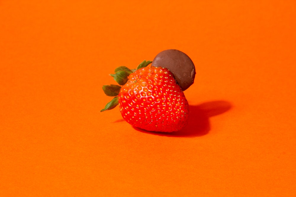 a close up of a strawberry on an orange background