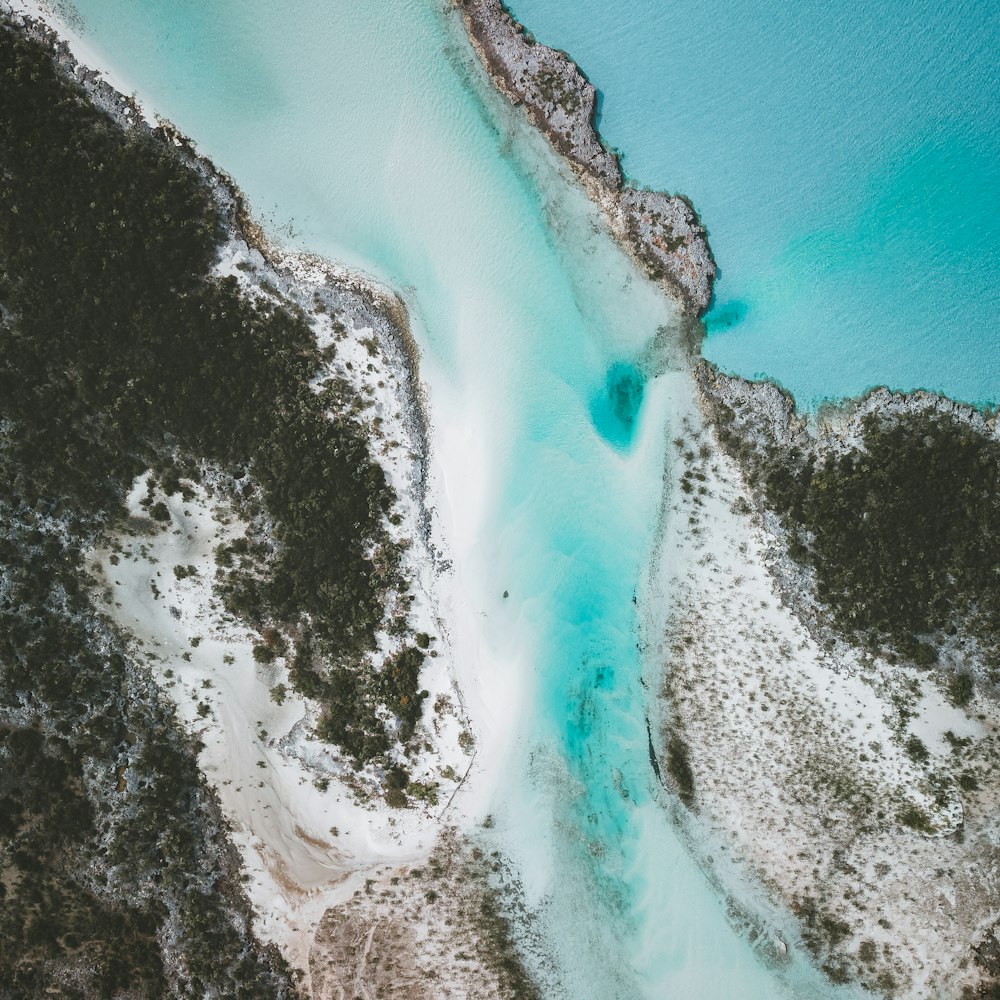 an aerial view of a body of water surrounded by trees