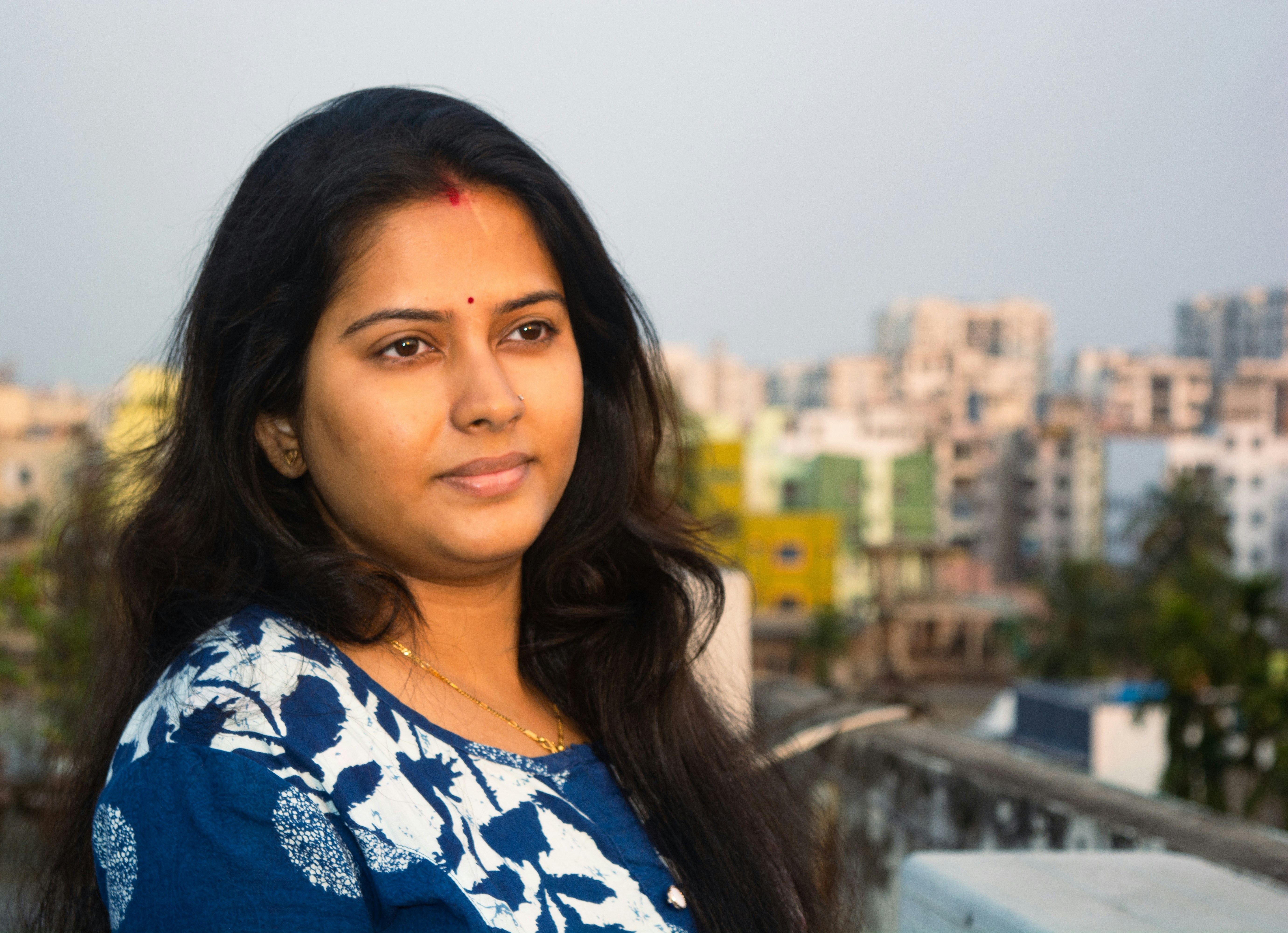 a woman standing in front of a cityscape