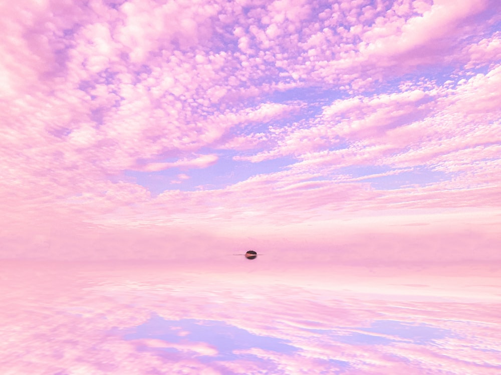 a pink and blue sky filled with clouds