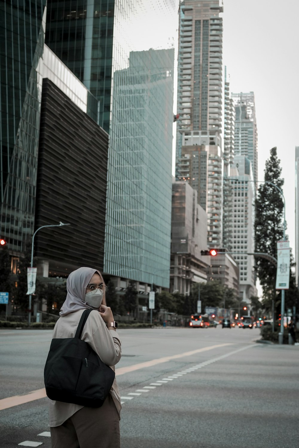 a woman in a hijab is on her cell phone