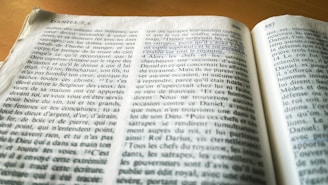 A book opened to a page with numbered paragraphs and headings, written in French. The text appears to be from a religious or philosophical work, and a section is underlined with a blue pen.