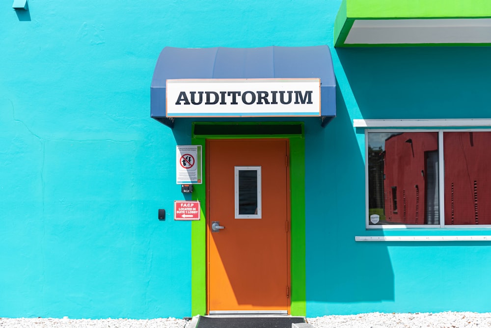 a brightly colored building with a door and window
