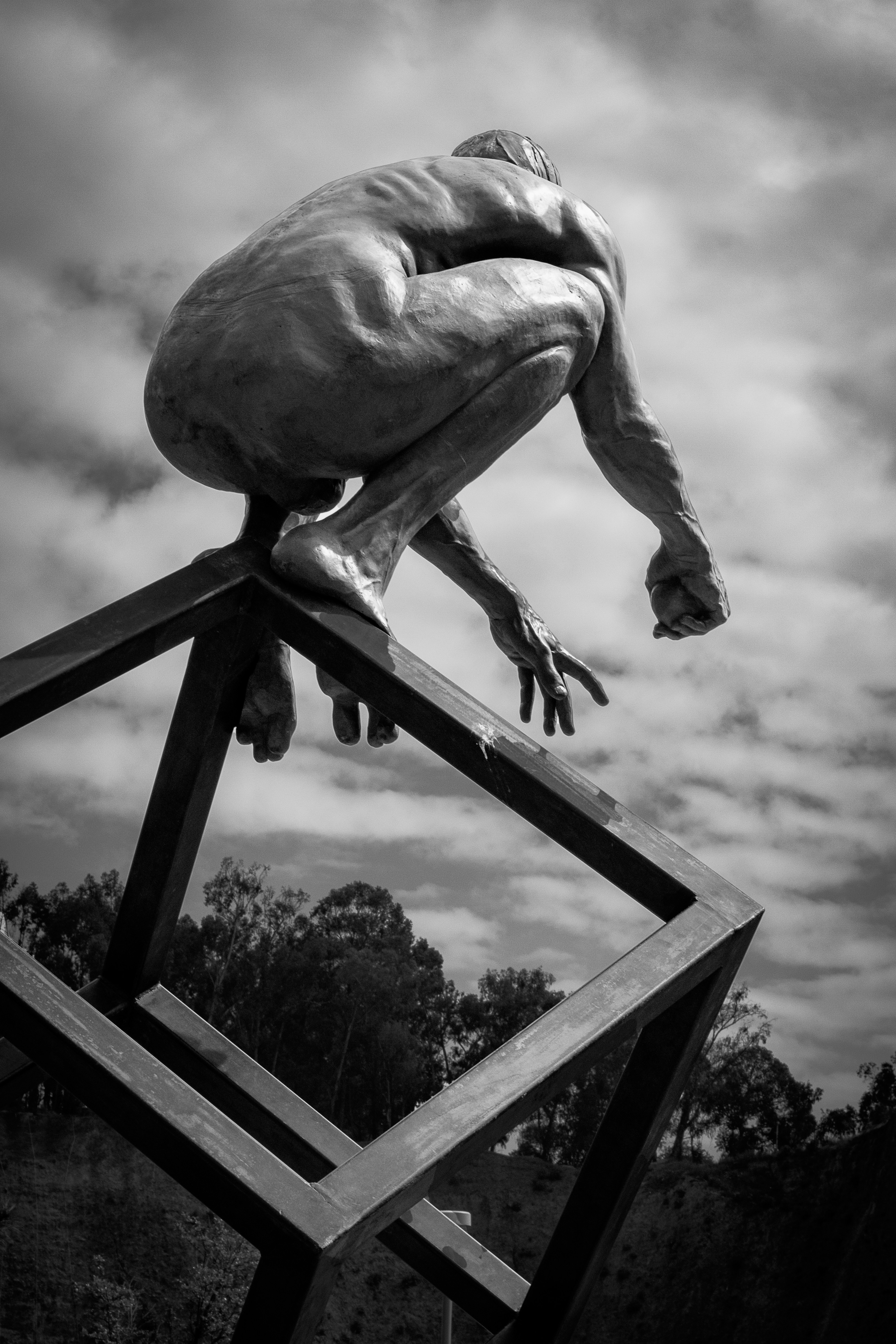 a statue of a man on top of a wooden structure