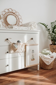 A cozy nursery corner with soft lighting and organized baby essentials.
