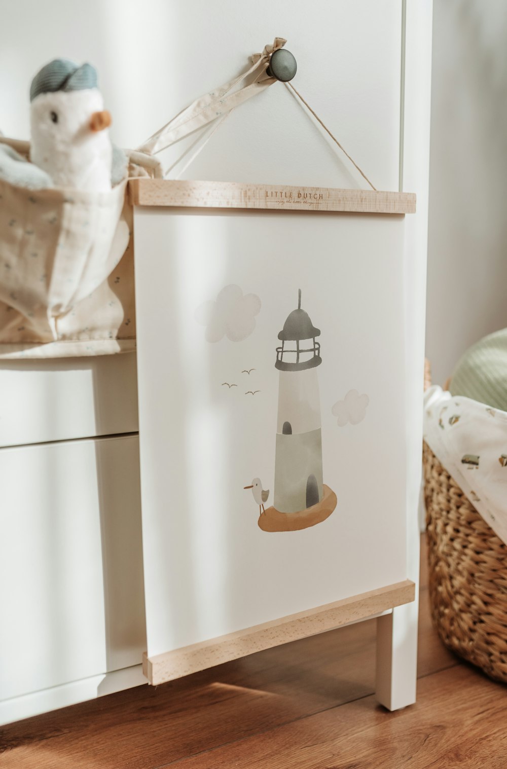 a picture of a lighthouse hanging on a wall