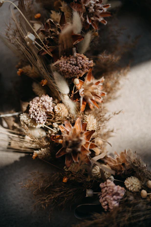 a bunch of dried flowers sitting on top of a table
