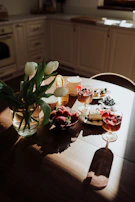 Guests enjoying their drinks and desserts at wooden tables near large windows with natural light.