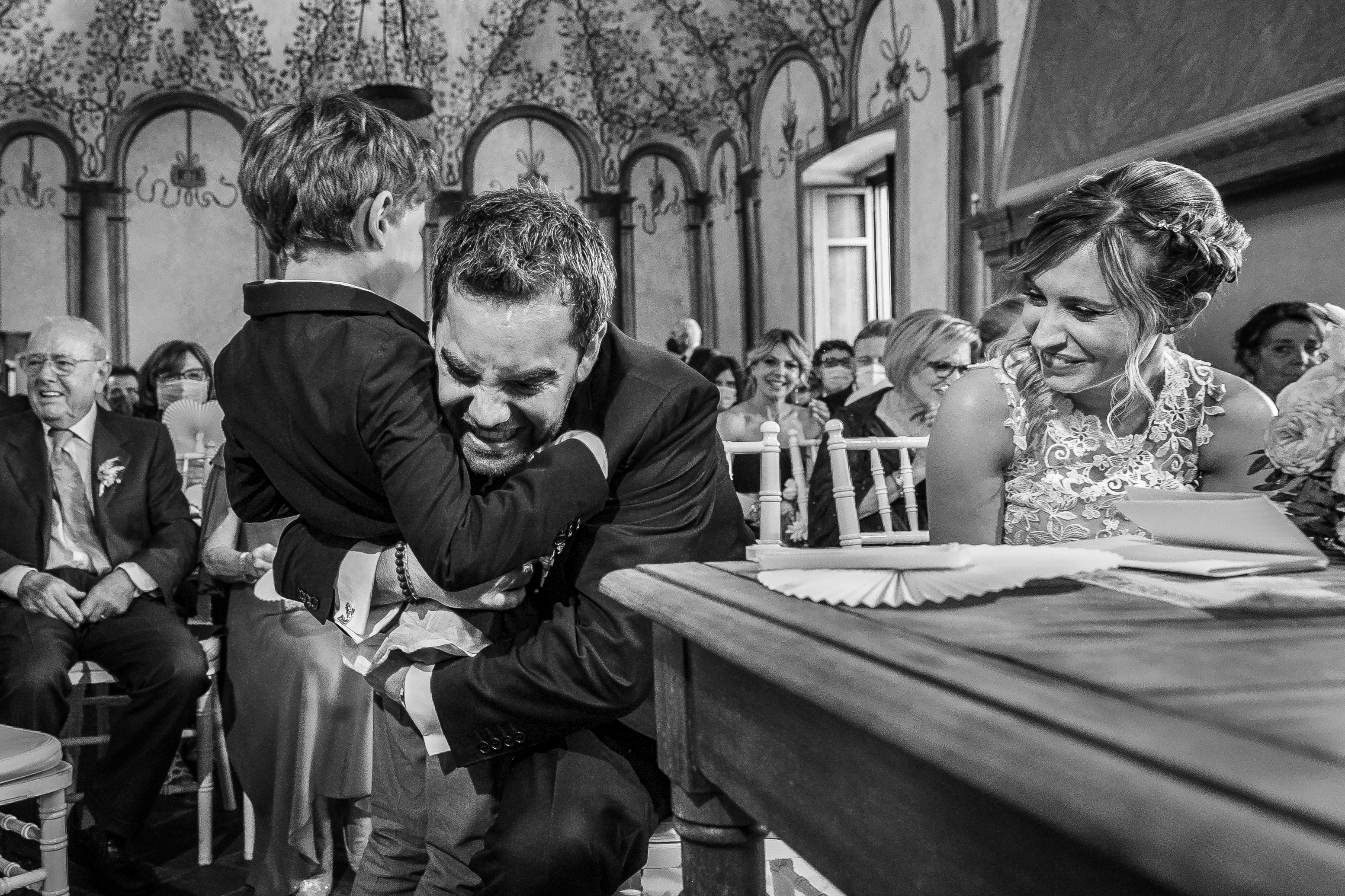 a black and white photo of a man hugging a woman