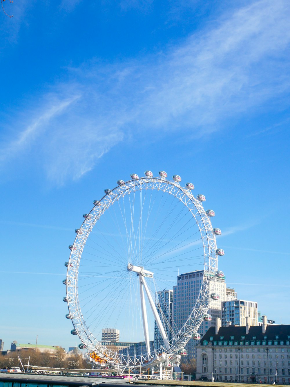 a large ferris wheel sitting next to a body of water