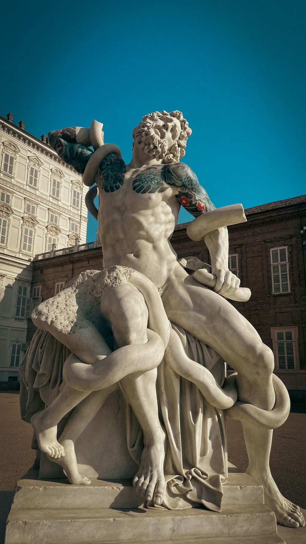 a statue of a man holding a tray of food