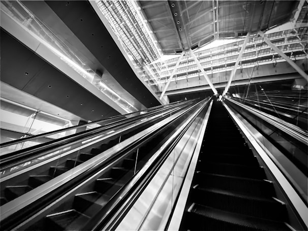 High-contrast black and white photograph of a fashion runway with bold, angular lighting.