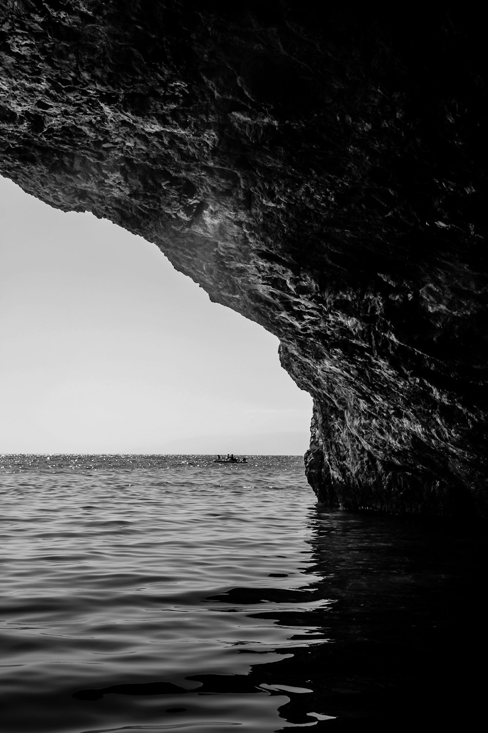 a black and white photo of a large cave