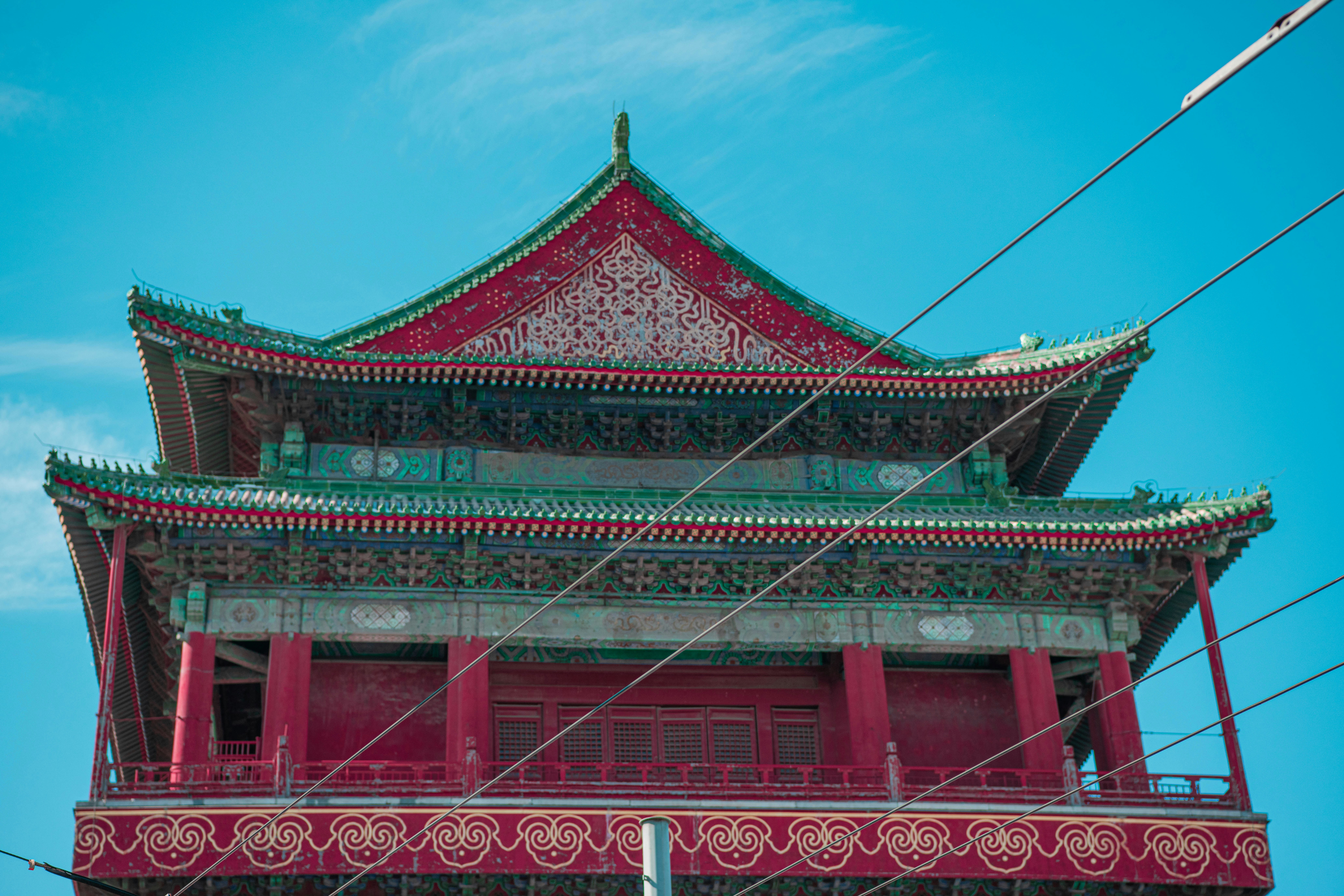 a tall red building with a sky background