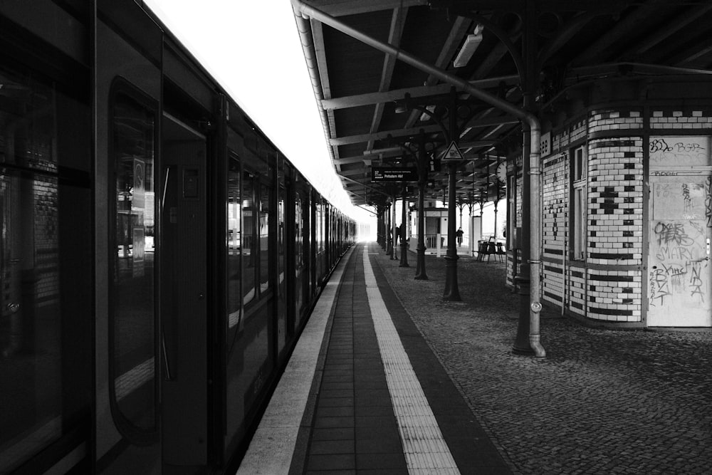 a black and white photo of a train at a train station