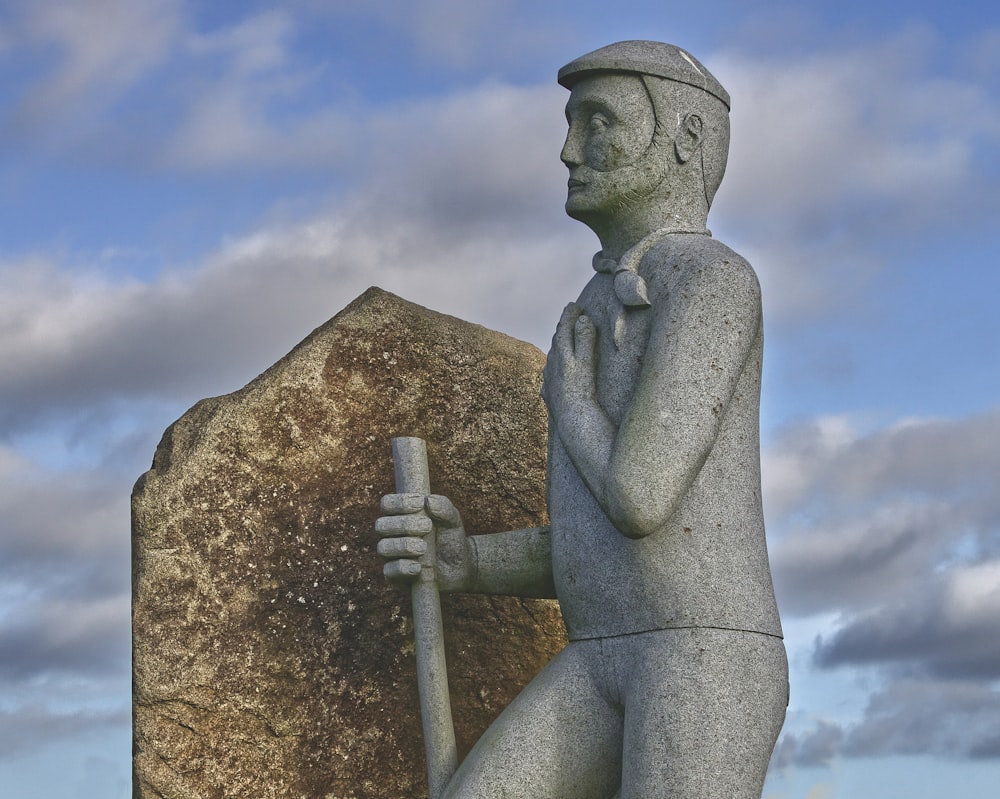 a statue of a man holding a baseball bat