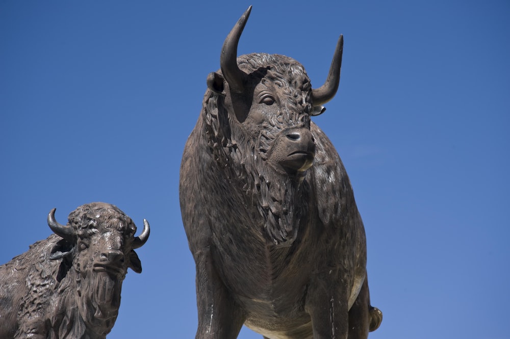 a statue of a bull and a buffalo standing next to each other