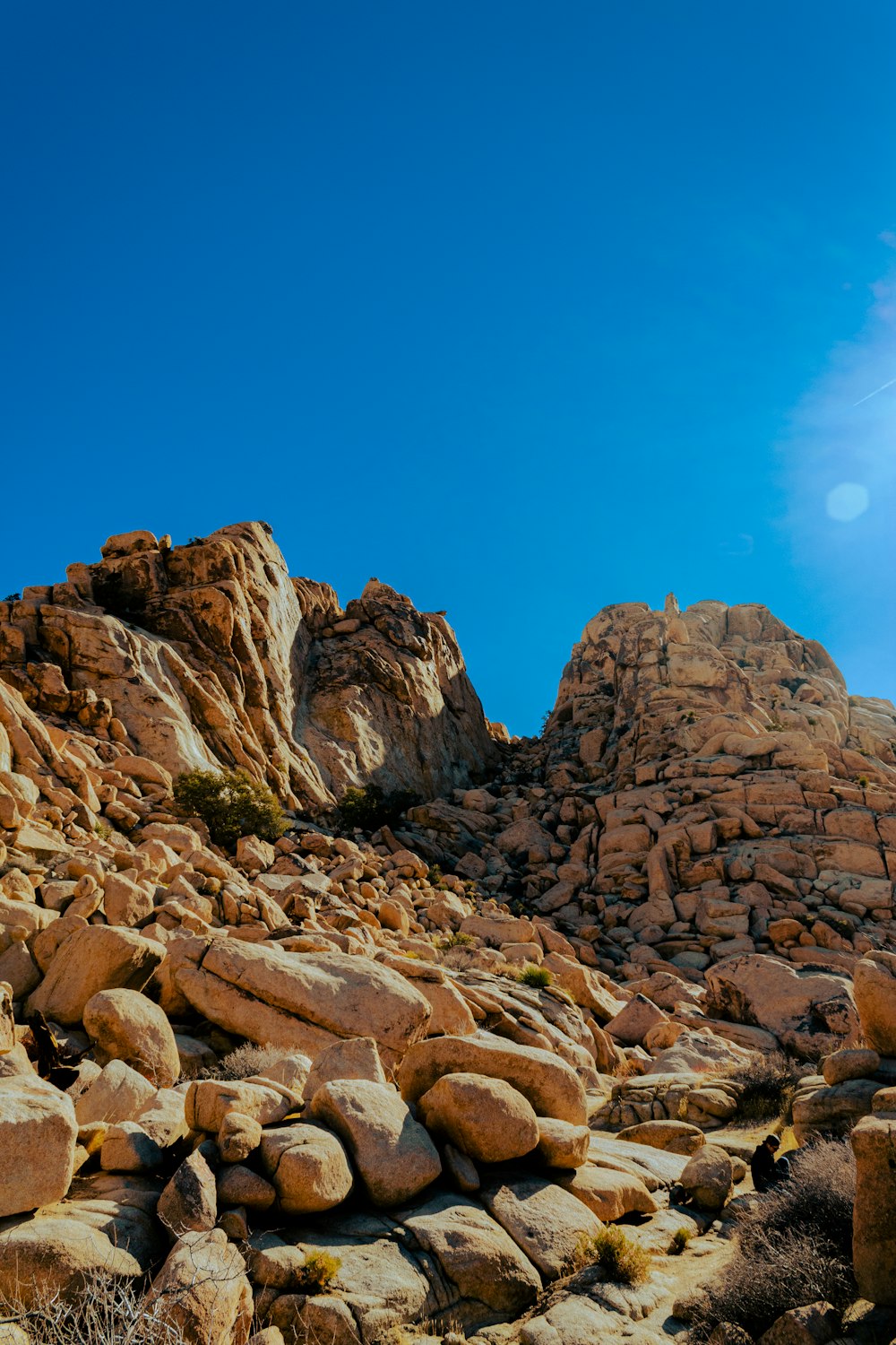 a rocky mountain side with rocks and grass