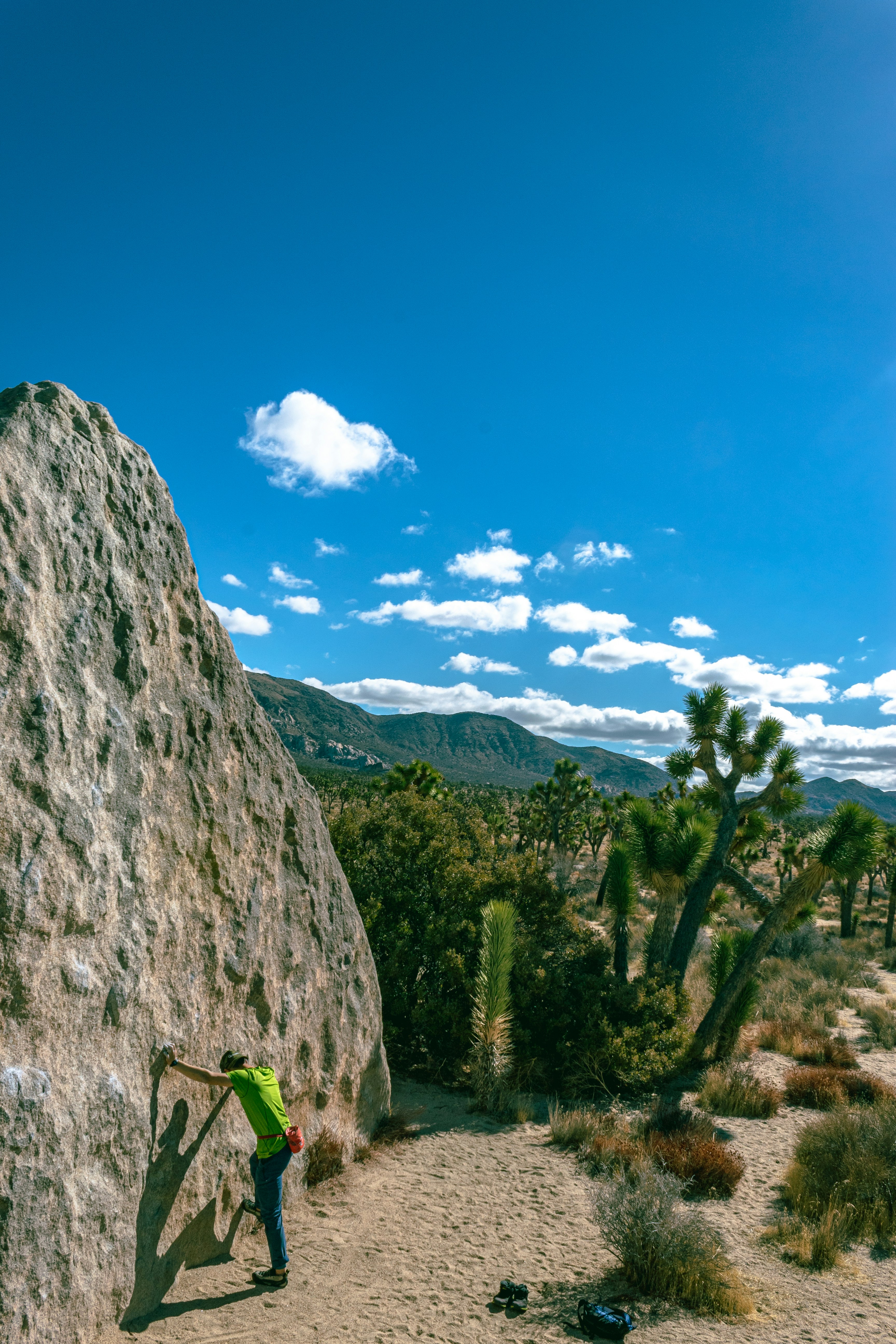 a man climbing up the side of a large rock