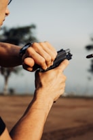 a man holding a cell phone in his right hand