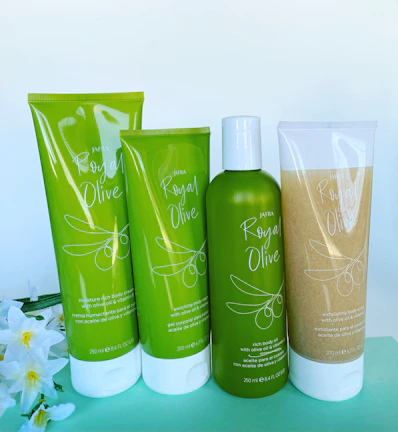 Elegant display of beauty and home care products with olive green and beige accents on a clean white background.