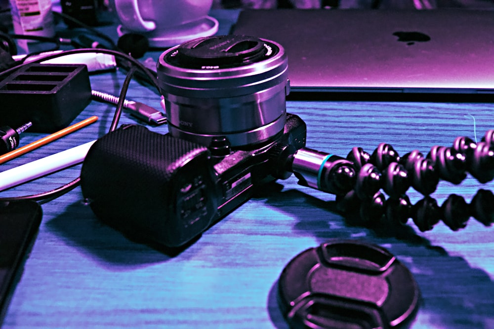 a camera sitting on top of a table next to a laptop