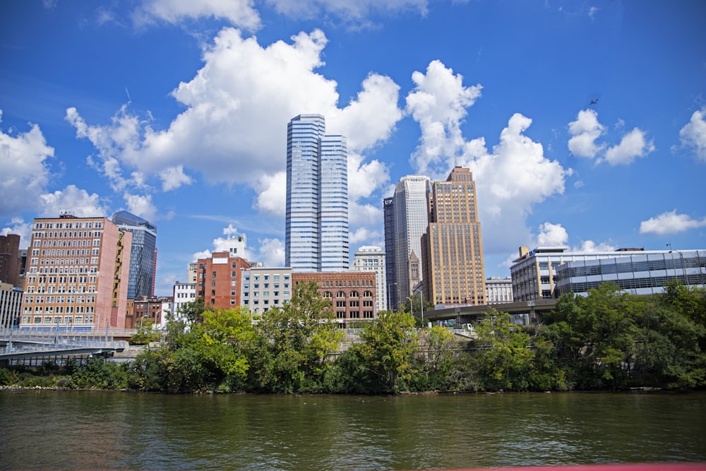 a river runs through a city with tall buildings