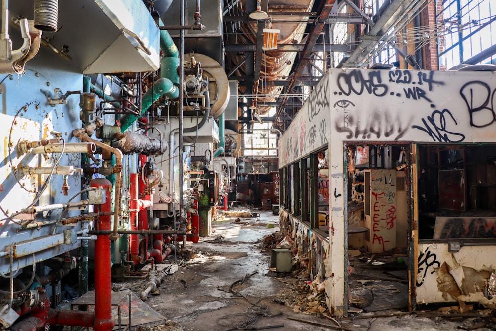 an old factory with lots of graffiti on the walls