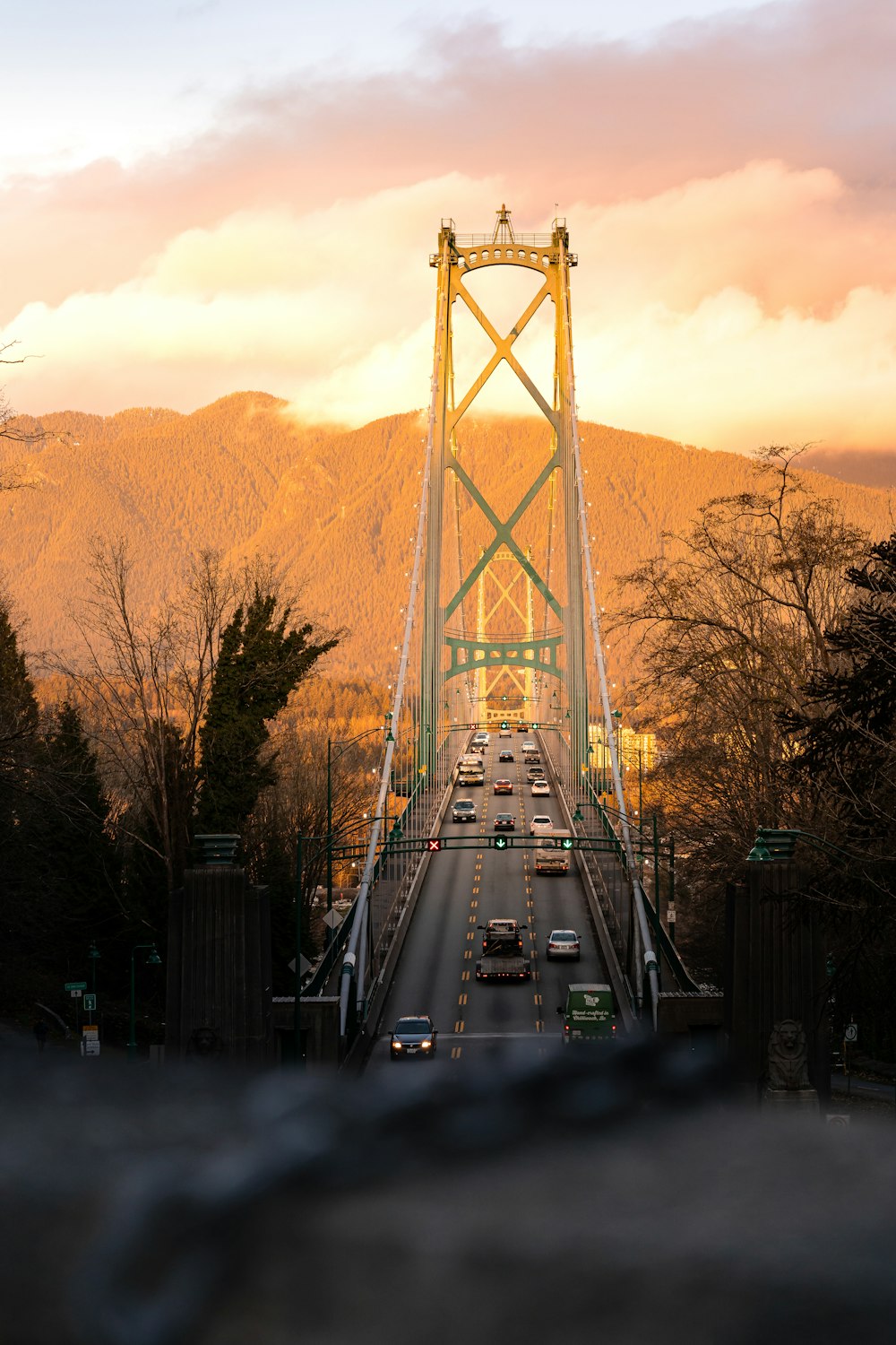 a view of a bridge over a road with mountains in the background