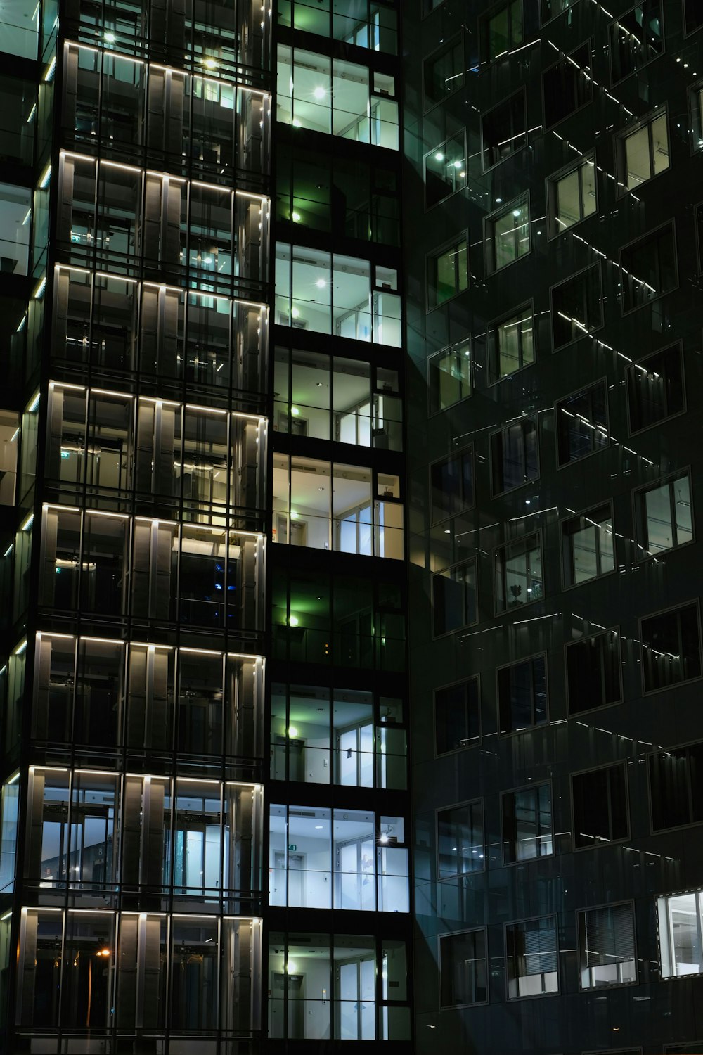 a very tall building with lots of windows at night